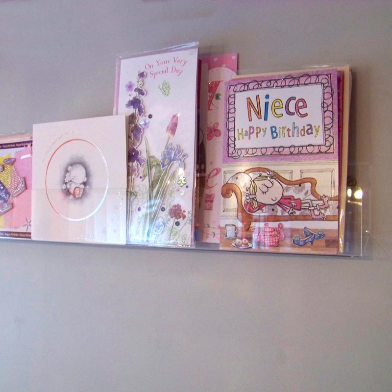 Side profile of economy greeting card rack installed on a wall.