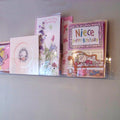 Side profile of economy greeting card rack installed on a wall.