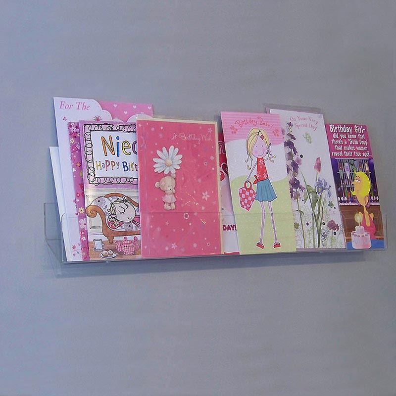 Side profile of 60cm standard greeting card rack installed on a wall.