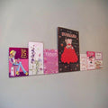 Image displaying 100cm single greeting card (0.5cm capacity) rack installed on wall.