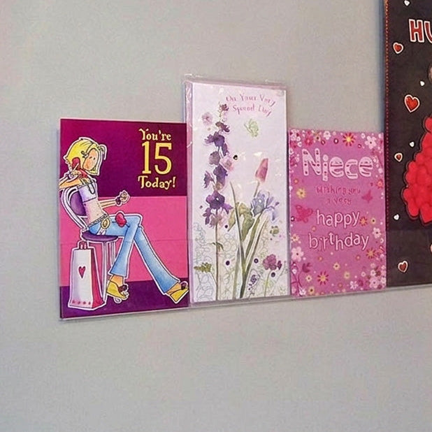 Side profile of single greeting card (0.5cm capacity) rack installed on wall.